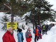 This file photo taken on December 17, 2017 shows mountain professionals standing linked together with ropes, as they take part in a rally to warn of the dangers to migrants in crossing passes in the Alps during the winter, in Nevache, French Alps.