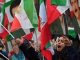 Protesters wave flags as they gather outside the Iranian Embassy in central London on January 2, 2018, in support of national demonstrations in Iran against the existing regime.