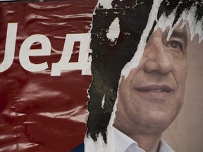 A picture taken on January 16, 2018 shows a ripped poster bearing a picture of leading Kosovo Serb politician Oliver Ivanovic who was killed in a brazen drive-by shooting in Mitrovica.