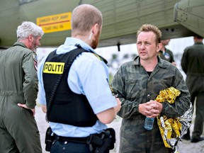This file photo taken on August 11, 2017 shows Peter Madsen (R), builder and captain of the private submarine UC3 Nautilus talking to a police officer in Dragoer Harbor south of Copenhagen, following a major rescue operation after the submarine sank. Madsen has since been convicted of the murder of reporter Kim Wall.