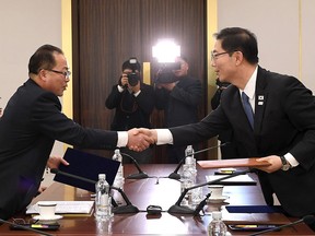 This handout photo provided by South Korean Unification Ministry on January 17, 2018 shows South Korean chief delegate Chun Hae-Sung (R) shaking hands with North Korean chief delegate Jon Jong-Su (L) as they exchange joint statements.