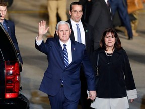 U.S. Vice President Mike Pence waves after stepping off a plane with his wife Karen Pence upon their arrival at Ben Gurion Airport near the Israeli city of Tel Aviv on January 21, 2018 on the second day of his delayed Middle East tour.