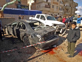 Libyans check the aftermath of an explosion in the eastern city of Benghazi on January 24, 2018.