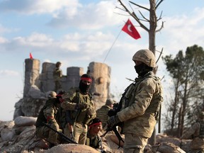 Pro-Turkey Syrian fighters and Turkish troops secure the Bursayah hill, which separates the Kurdish-held enclave of Afrin from the Turkey-controlled town of Azaz, Syria, in a photo taken Jan. 28, 2018.