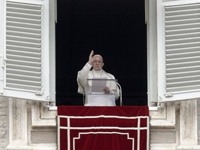 Pope Francis recites the Angelus noon prayer from the window of his studio overlooking St. Peter's Square, at the Vatican, Sunday, Jan. 7, 2018.