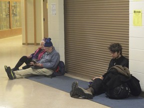 Jan Knutson, left, and her husband Ed Hutchinson, center, and a man at about 2:30 a.m. Tuesday, Jan. 23, 2018, wait for the all-clear at Homer High School during a tsunami alert for Homer, Alaska. The city of Homer issued an evacuation order for low-lying areas shortly after an earthquake hit.