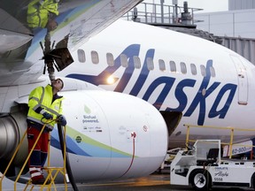 In this Monday, Nov. 14, 2016, photo, fuelling manager Jarid Svraka looks on as he fuels an Alaska Airlines Boeing 737-800 jet at Seattle-Tacoma International Airport in SeaTac, Wash. On Tuesday, Dec. 6, 2016.