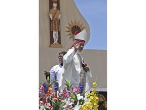 Osornos Bishop Juan Barros waves as he leaves the altar after Mass was celebrated by Pope Francis on Lobito Beach in Iquique, Chile, Thursday, Jan. 18, 2018. Many Chileans are furious over Francis' 2015 decision to appoint Barros, a bishop close to the Rev. Fernando Karadima, who the Vatican found guilty in 2011 of abusing dozens of minors over decades. Barros has always denied he knew what Karadima was doing when he was the priest's protege, a position that many Chileans have a hard time believing.