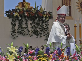 Osornos Bishop Juan Barros smiles as he leaves the altar after Mass was celebrated by Pope Francis on Lobito Beach in Iquique, Chile, Thursday, Jan. 18, 2018. Many Chileans are furious over Francis' 2015 decision to appoint Barros, a bishop close to the Rev. Fernando Karadima, who the Vatican found guilty in 2011 of abusing dozens of minors over decades. Barros has always denied he knew what Karadima was doing when he was the priest's protege, a position that many Chileans have a hard time believing.