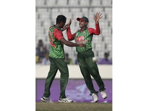 Bangladesh's Rubel Hossain, left, celebrates with his teammate Mehidy Hasan Miraz the dismissal of Sri Lanka's Shehan Madushanka during the final match of the Tri-Nation one-day international cricket series in Dhaka, Bangladesh, Saturday, Jan. 27, 2018.