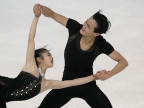 FILE - In this Friday, Sept. 29, 2017, file photo, Ryom Tae Ok and Kim Ju Sik of North Korea compete during the pairs free program at the Figure Skating-ISU Challenger Series in Oberstdorf, Germany. The 22 North Korean athletes now invited to compete at the Olympics in February 2018 are not likely to bring home any medals across the border from South Korea. Of all the athletes given late entries in five sports, only the figure skating pair met the qualifying standard on merit.