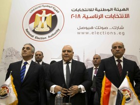 Lasheen Ibrahim, head of the National Electoral Commission, which is in charge of supervising the 2018 Egyptian presidential election, center, and members of the commission prepare to give a press conference at the commission headquarters in Cairo, Egypt, Monday, Jan. 8, 2018.  The commission announced Monday that the presidential election is to be held March 26-28, with the runoff in April.