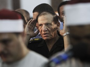 FILE - In this Aug. 5, 2012 file photo, then Egyptian armed forces Chief of Staff, Sami Annan performs prayers for 16 Egyptian soldiers who were killed, in Cairo, Egypt. A senior Muslim Brotherhood leader has written an open letter to Annan, a retired Egyptian army general seeking to run for president, listing the outlawed group's conditions for supporting his candidacy against Abdel-Fattah el-Sissi, a general-turned-president who has decimated the Brotherhood since removing it from power in 2013.