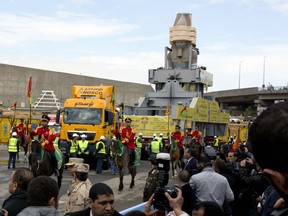 The statue of Egyptian Pharaoh Ramses II is surrounded by honour guards as it is moved to be displayed at a permanent location at the Grand Egyptian Museum (GEM) in Cairo, Egypt, Thursday, Jan. 25, 2018.