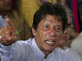 FILE - In this July 28, 2017 file photo, Pakistani opposition leader Imran Khan gestures during a news conference in Islamabad, Pakistan. Khan said Saturday, Jan. 13, 2018 that meeting U.S. President Donald Trump would be a "bitter pill" to swallow should he become Pakistan's prime minister in elections later this year, but added "I would meet him."