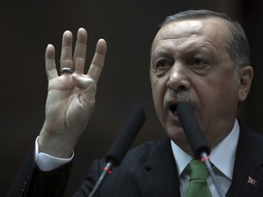 Turkey's President and leader of ruling Justice and Development Party Recep Tayyip Erdogan addresses his lawmakers at the parliament in Ankara, Turkey, Tuesday, Jan. 16, 2018. Erdogan on Tuesday called on NATO to take a stance against the United States, a fellow ally, over its plans to form a 30,000-strong Kurdish-led border security force in Syria. Turkey has been threatening to launch a new military offensive in Syria against Syrian Kurdish militias, which Turkey considers to be terrorists because of their affiliation with outlawed Kurdish rebels fighting Turkey.