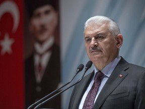 Turkey's Prime Minister Binali Yildirim speak to the country's security chiefs in Ankara, Turkey, Thursday, Jan. 18, 2018. Yildirim on Thursday complained about inconsistent statements from the United States concerning the creation of a border secruty force in northern Syria, saying Washington has to put an end to the confusion and stand by Turkey. (Pool Photo via AP)