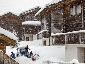 A general view of the heavy snowfall in Saas Fee village, near Zermatt in the Swiss Alps, Tuesday, Jan. 9, 2018. Unusually heavy snowfall and a high risk of Alpine avalanches stranded some 13,000 tourists Tuesday in the Swiss resort of Zermatt at the base of the famed Matterhorn mountain. With nearby roads, trains, cable cars, ski slopes and hiking trails into the town closed, Swiss authorities deployed helicopters to ferry some tourists to a nearby village to escape the snow-bound Alpine valley.