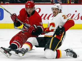 Carolina Hurricanes' Elias Lindholm collides with Calgary Flames' Travis Hamonic during the second period Sunday in Raleigh, N.C.