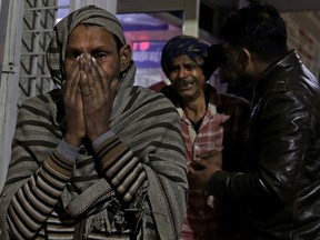 Relatives of firecracker factory fire victim, wail at a hospital on the outskirts of New Delhi, India, early Sunday, Jan. 21, 2018. A big fire broke out at a firecrackers factory on the northern outskirts of the Indian capital on Saturday, killing at least 17 workers, a fire official said.