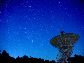 A communications satellite  looks into the night sky.