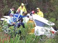 In this Monday, Jan. 15, 2018, photo taken and provided by Michael Lethbridge, emergency services officers work to cut his nephew Samuel Lethbridge, 17, from the wreck of his car off the Pacific Highway south of Swansea in New South Wales state, Australia.