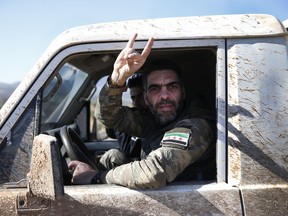 Turkey-backed Syrian opposition fighters of the Free Syrian Army drive towards the border with Syria, in the outskirts of the border town of Kilis, Turkey, Tuesday, Jan. 30, 2018. Turkey launched a military offensive against Afrin on Jan. 20 to drive out the Syrian Kurdish People's Protection Units, or YPG, which is says are an extension of the outlawed Kurdish rebels inside Turkey.