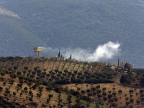 Smoke billows from a position inside Syria, after a Turkish Army artillery fired, as seen from the outskirts of the village of Sugedigi, Turkey, adjacent to the border with Syria, Sunday, Jan. 21, 2018.  Turkey's ground troops entered the enclave of Afrin, in northern Syria on Sunday and were advancing with Turkish-backed Syrian opposition forces in their bid to oust Syrian Kurdish forces from the region.