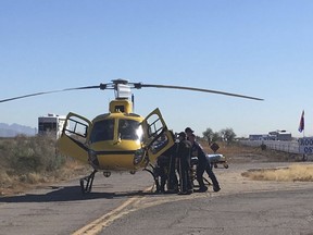 First responders load an injured passenger onto a helicopter for transportation to a hospital Friday, Dec. 29, 2017 at Rooster Cogburn Ostrich Ranch in Picacho, Ariz. Twelve people were injured when the tour truck they were riding in rolled over.