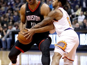 Houston Rockets guard Eric Gordon tries to drive on Phoenix Suns guard Tyler Ulis (8) during the first half of an NBA basketball game Friday, Jan. 12, 2018, in Phoenix.