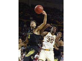 Oregon forward M.J. Cage (4) battles with Arizona State forward De'Quon Lake (35) for a rebound during the first half of an NCAA college basketball game, Thursday, Jan. 11, 2018, in Tempe, Ariz.