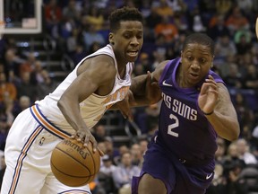 New York Knicks guard Frank Ntilikina and Phoenix Suns guard Isaiah Canaan (2) vie for the ball during the first half of an NBA basketball game Friday, Jan. 26, 2018, in Phoenix.