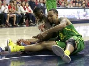 Arizona guard Rawle Alkins and Oregon forward Paul White (13) battle for a loose ball in the first half during an NCAA college basketball game, Saturday, Jan. 13, 2018, in Tucson, Ariz.