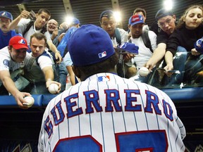 In this Sept. 17, 2003 file photo, Montreal Expos outfielder Vladimir Guerrero signs autographs before the team's final home game of the season.