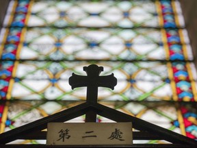 A cross is seen inside St. Joseph's church, also known as Wangfujing church in Beijing on January 25, 2018. The Vatican is keen to bring the entire Chinese Catholic community of some 10 to 12 million people back into the fold and talks have been underway since 2014.