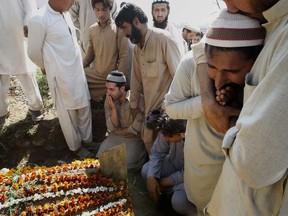In this March 18, 2015 file photo, Pakistani villagers and family members mourn during the funeral of Pakistani lawyer Samiullah Khan Afridi, who was killed months after he announced that he will no longer be representing Dr. Shakil Afridi, in Peshawar, Pakistan. Shakil Afridi, who reportedly used a vaccination scam to identify Osama bin Laden's home, has been languishing in jail since the al-Qaida leader was killed by U.S. Navy Seals in 2011.