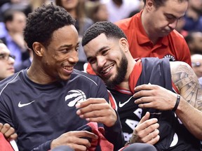 Toronto Raptors guards DeMar DeRozan, left, and Fred VanVleet joke around on the bench late in a blowout win over the Cleveland Cavaliers on Jan. 11.