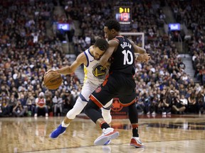 Golden State Warriors guard Stephen Curry drives to the basket against Toronto Raptors guard DeMar DeRozan on Jan. 13.