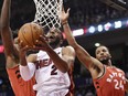 Miami Heat guard Wayne Ellington goes up for a shot past Toronto Raptors forward Norman Powell, right, and centre Lucas Nogueira in Toronto on Tuesday.