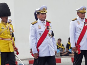 FILE - In this Oct. 26, 2017, photo, Thai Prime Minister Prayuth Chan-ocha, center, participates in the funeral procession and royal cremation ceremony of late Thai King Bhumibol Adulyadej, in Bangkok, Thailand. The world's only nation still under formal military rule, Thailand is under increasing pressure both at home and abroad to return to civilian governance. The message now appears clear: In one form or another, the gruff general wants to be that civilian.