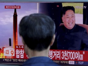 In this Friday, Sept. 15, 2017, file photo, a man watches a TV screen showing a file footage of North Korea's missile launch and North Korean leader Kim Jong Un, at the Seoul Railway Station in Seoul, South Korea.