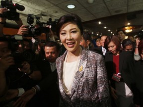 FILE - In this In this Thursday, Jan. 22, 2015, file photo, Thailand's former Prime Minister Yingluck Shinawatra, arrives at parliament in Bangkok, Thailand. Thailand's foreign minister says Yingluck, who fled the country last year to evade a prison sentence, is in Britain, after photos surfaced online apparently showing Yingluck in London.