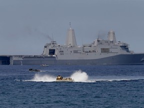 FILE - In this Tuesday, April 21, 2015, file photo, U.S. Navy's amphibious assault vehicles with Philippine and U.S. troops on board maneuver in the waters during a combined assault exercise facing the contested Scarborough Shoal in waters off of the Philippines. The Chinese government, Saturday, Jan 20, 2018, accused the U.S. of trespassing in its territorial waters when a U.S. guided missile destroyer sailed near the disputed Scarborough Shoal in the South China Sea.
