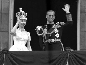 A June 2, 1953 file photo of Britain's Queen Elizabeth II and Prince Philip, Duke of Edinburgh, as they wave to supporters from the balcony at Buckingham Palace, following her coronation at Westminster Abbey. London.