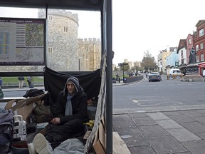Stuart, no surname given, with his possessions in a bus stop near Windsor Castle, in background, in Windsor, England, Thursday, Jan. 4, 2017.