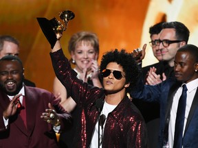 Bruno Mars (C) accepts Album of the Year for '24K Magic' with production team onstage during the 60th Annual GRAMMY Awards at Madison Square Garden on January 28, 2018 in New York City.