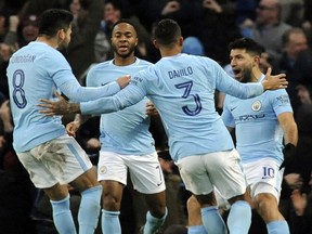 Manchester City's Sergio Aguero, right, celebrates after scoring his side's first goal during the English FA Cup Third Round soccer match between Manchester City and Burnley at Etihad stadium in Manchester, England, Saturday, Jan. 6, 2018.