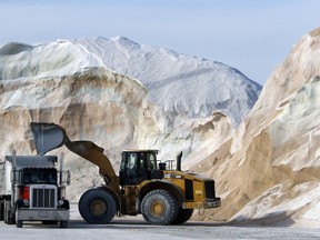 Road salt is loaded into a truck surrounded by mountains of salt at Eastern Minerals Inc., Wednesday, Jan. 3, 2018, in the Boston suburb of Chelsea, Mass. The National Weather Service has issued a blizzard warning for Thursday that extends from Block Island, R.I., north to coastal Maine. Most of the rest of southern New England is under a winter storm watch.