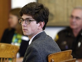 FILE - In this Tuesday Aug. 18, 2015 file photo, St. Paul's School student Owen Labrie looks around the courtroom at the start of his trial. Labrie was convicted of sexually assaulting a 15-year-old freshman girl as part of a game of sexual conquest. The prep school announced Friday, Jan. 19, 2018, it had settled a lawsuit filed by the parents of the student who accused Labrie of was sexually assaulting their daughter in 2014.