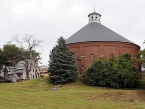 FILE - In this Oct. 2, 2015 file photo, the Concord gasholder building, built in 1888, is pictured in Concord, N.H. The 130-year-old red-brick coal gasholder building is believed to be the last of its type in the country and has been named to the National Register of Historic Places.